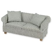 Sofa gris à pois avec 2 coussins